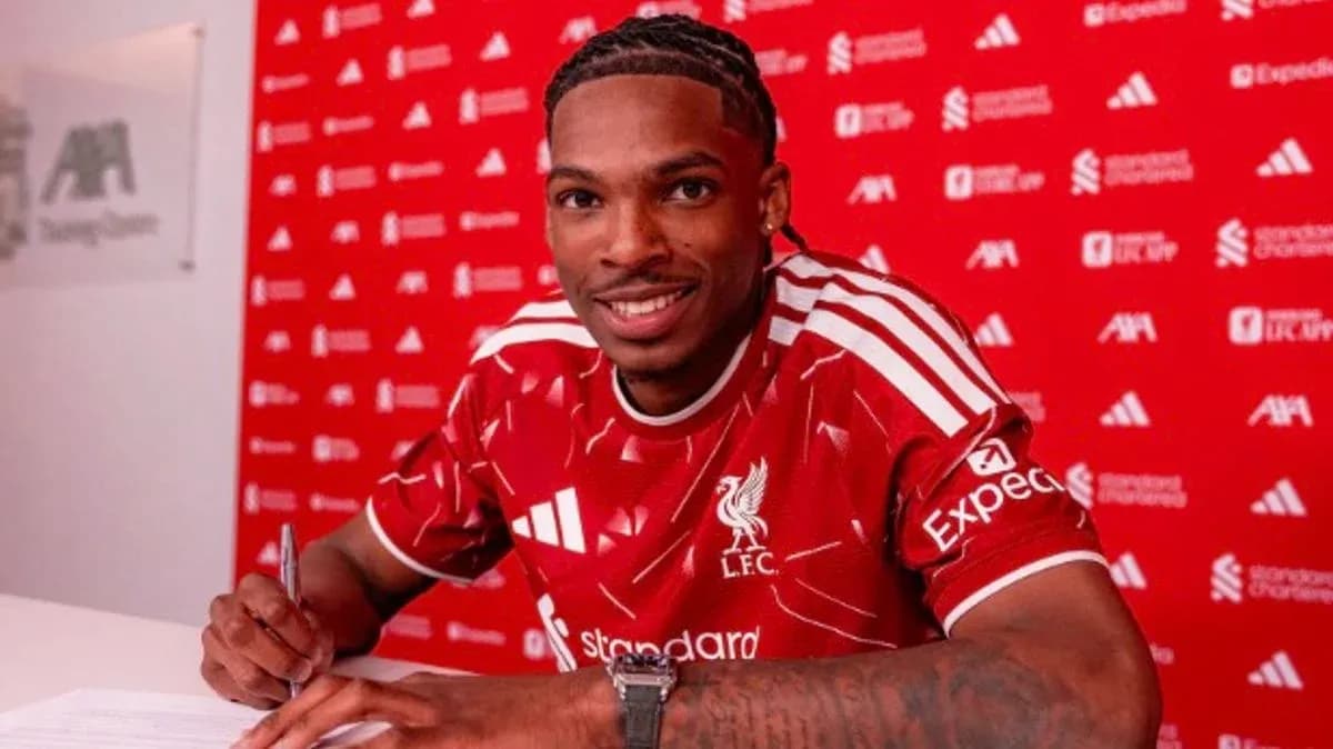 Jugador firmando contrato con Liverpool en conferencia