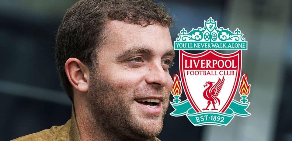 Hombre sonriendo junto al logo del Liverpool FC
