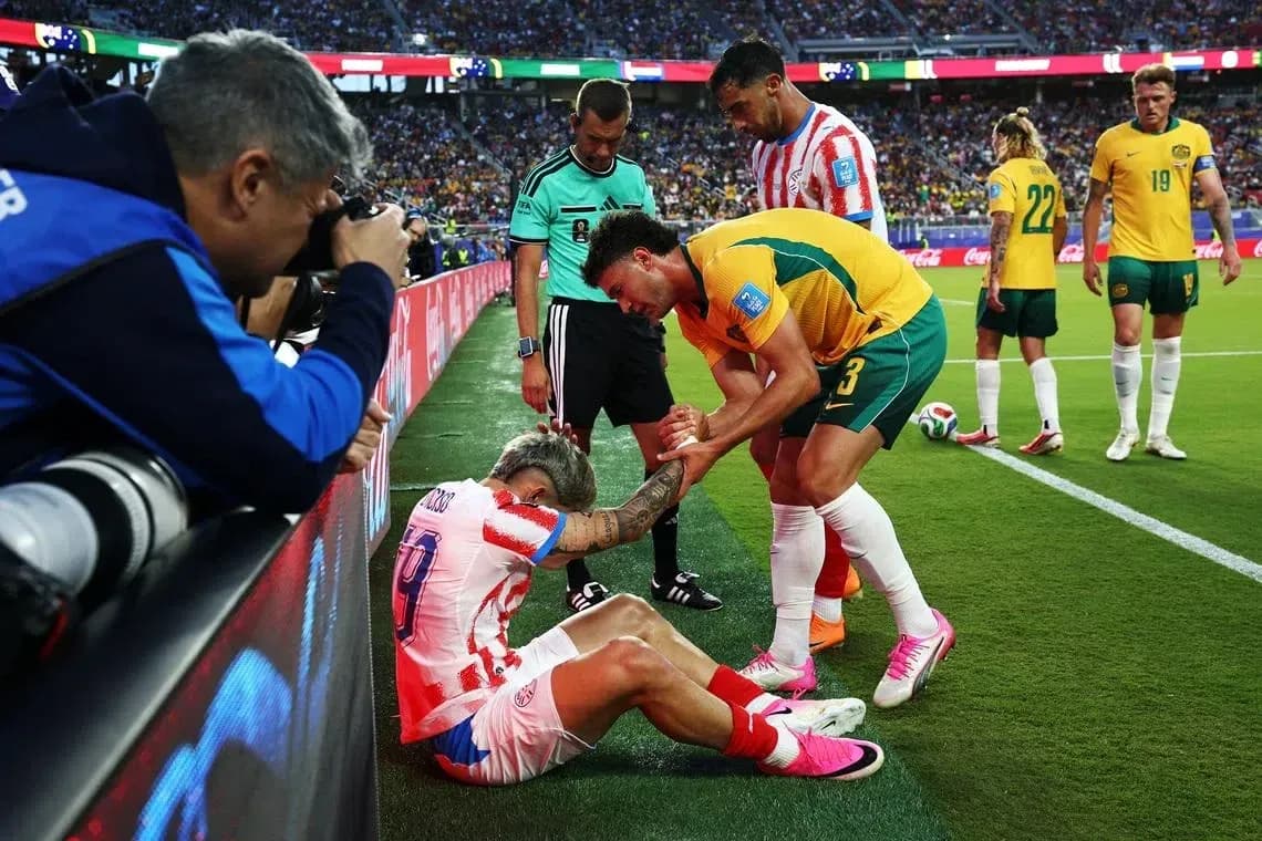 Jugador lesionado siendo asistido por oponente y árbitro