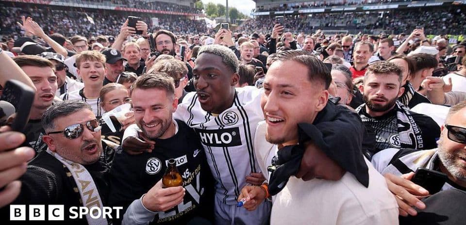 A celebratory crowd with players after a match