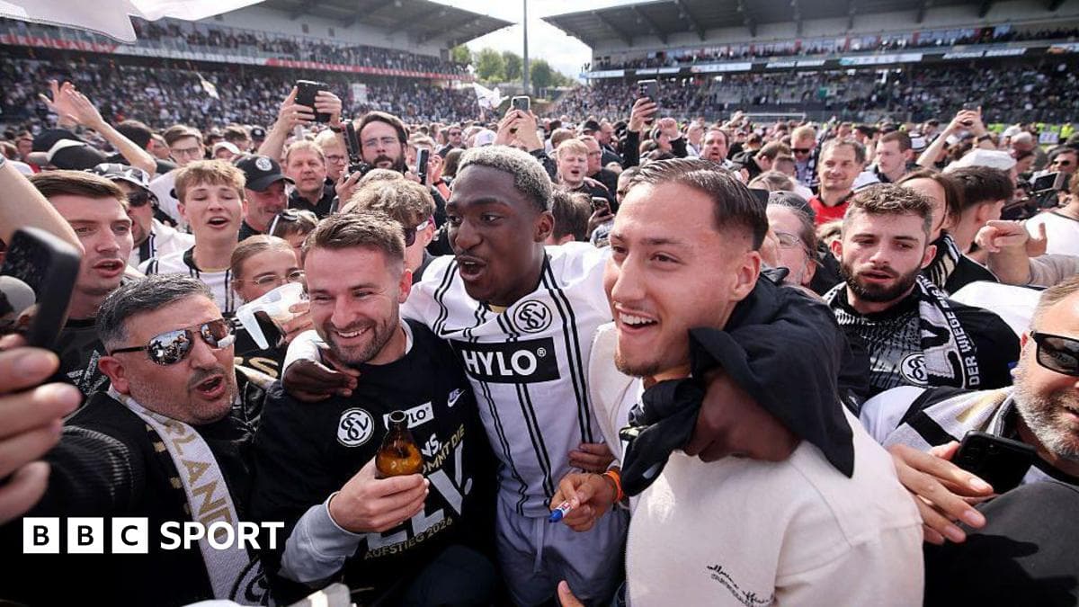 A celebratory crowd with players after a match