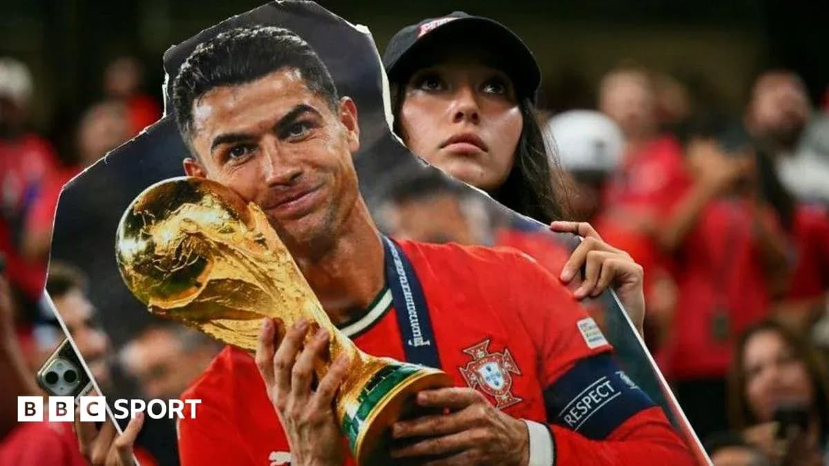 A fan holding a cutout of Cristiano Ronaldo