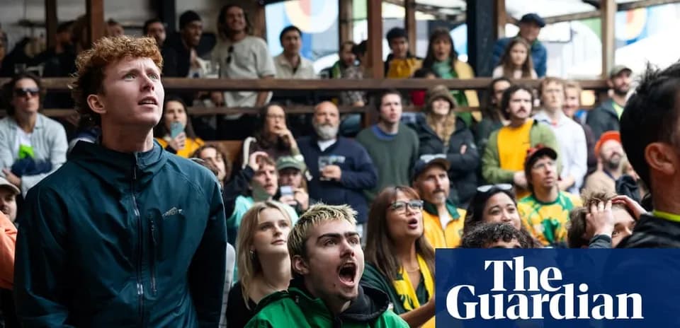 A group of fans watching a sporting event